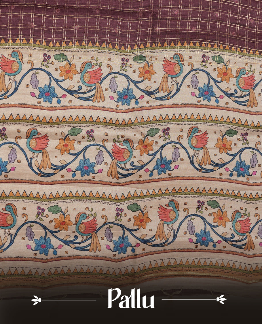 Maroon colour semi tusser silk saree featuring gold zari check pattern with floral butti motifs, with contrast floral kodi & bird pattern and paired with matching blouse.