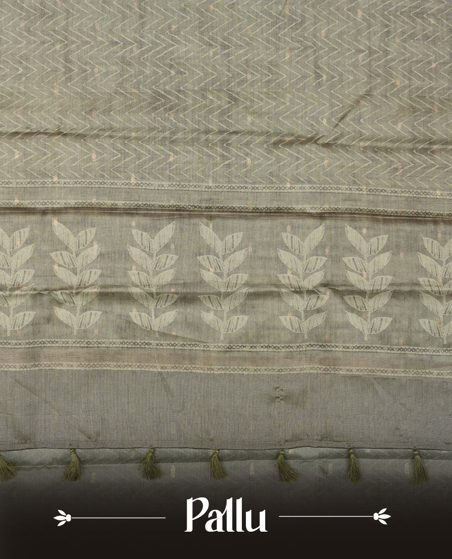 Olive sage colour semi tussar saree adorned with Cream Zigzag printed pattern across the body and Leaf pattern on contrast olive sage colour border, paired with a matching blouse.