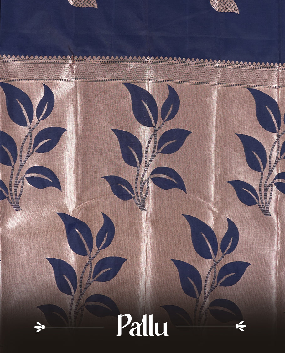 Dark blue colour semi silk saree adorned with elegant floral motifs on the body, complemented by a shimmering golden zari-woven pallu and border, and paired with a matching blouse