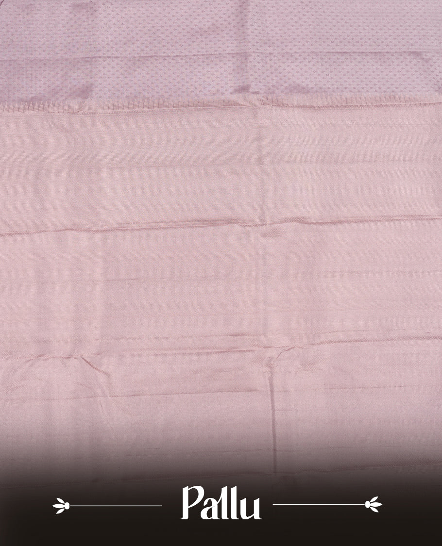Dusty Lavender colour Vasundhara silk saree featuring self colour motifs across the body, finished with a self‑coloured tiny daimond pattern with gold tree motifs on border and a coordinating blouse.