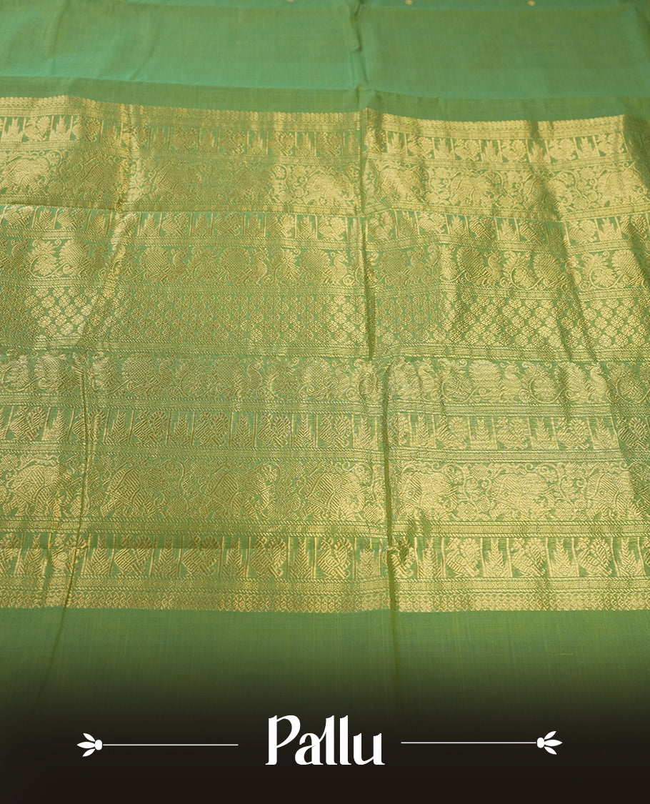 Fern Green colour Pure Kanchi cotton saree featuring delicate golden buttas and a rich zari border with intricate motifs & Paired with a matching blouse, it exudes timeless elegance, perfect for festive and traditional occasions.