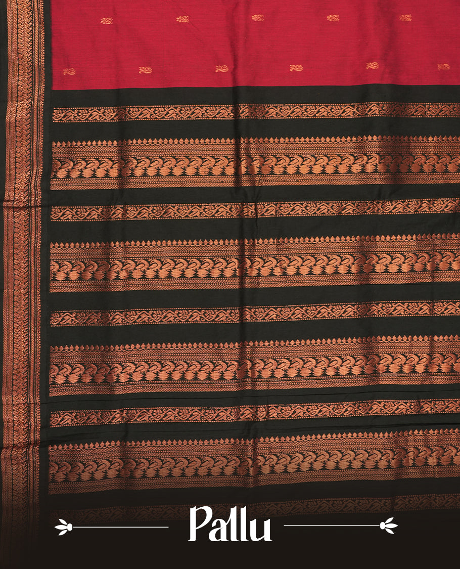 Deep maroon colour Kalyani cotton saree featuring delicate zari motifs work on the body, highlighted with an elegant contrast black zari woven border & Paired with a matching blouse.