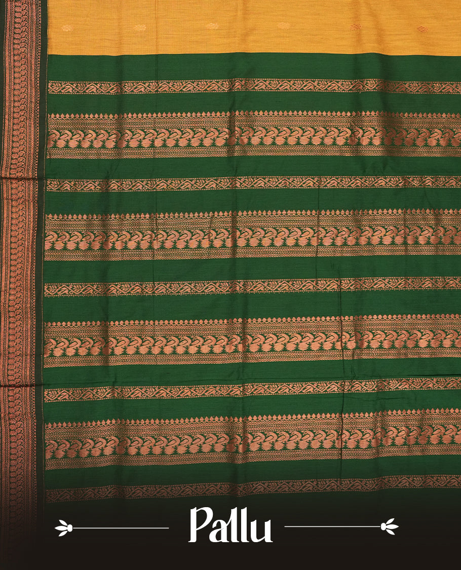 Mustard yellow colour Kalyani Cotton saree with delicate woven zari motifs all over, paired with a contrasting deep green border and pallu intricately woven with rich copper zari & Comes with a matching blouse piece.