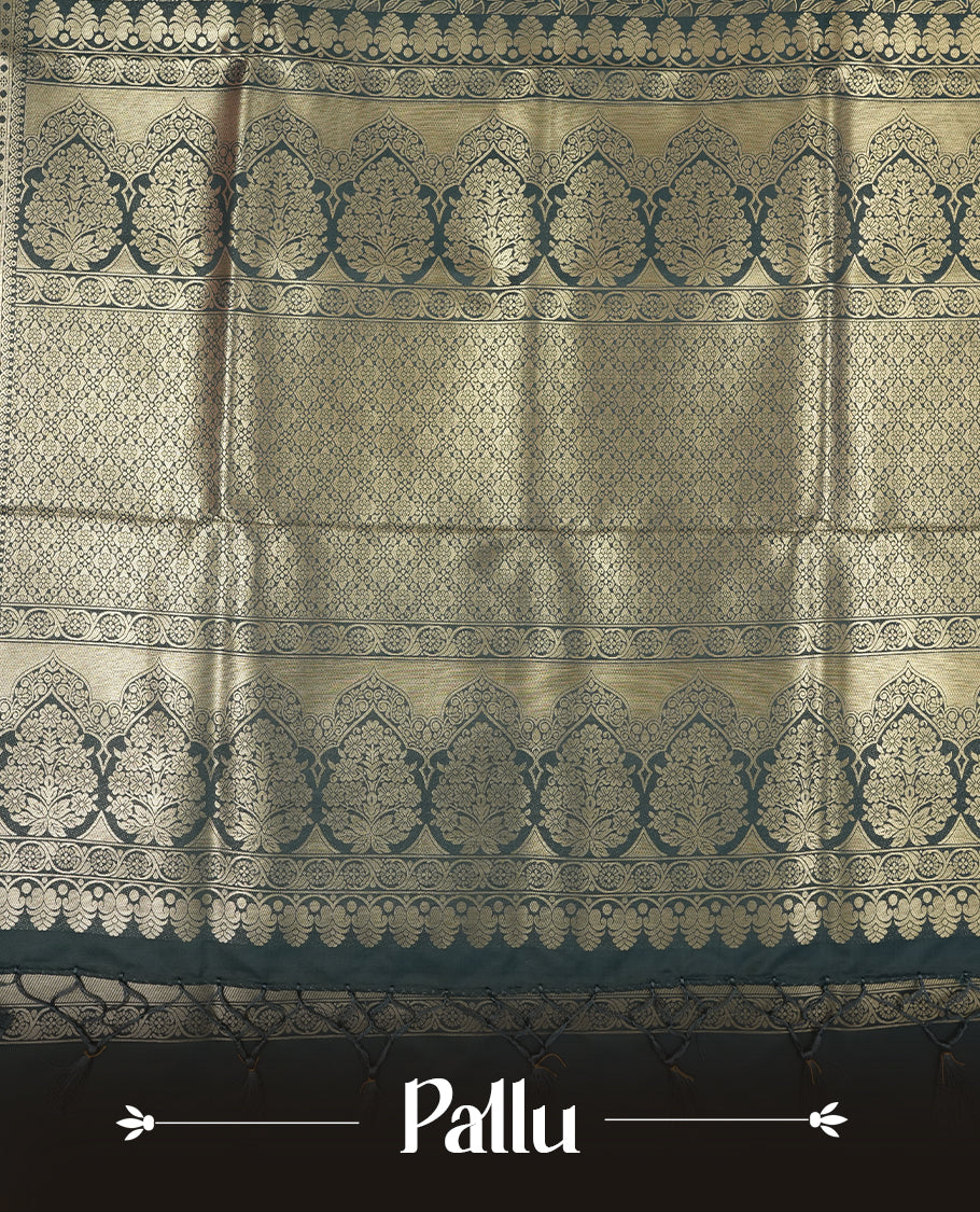 Dark Teal Green colour semi soft silk saree featuring an all-over woven leaf pattern in gold colour, finished with a matching border adorned with detailed paisley and floral motifs, and a matching blouse piece.