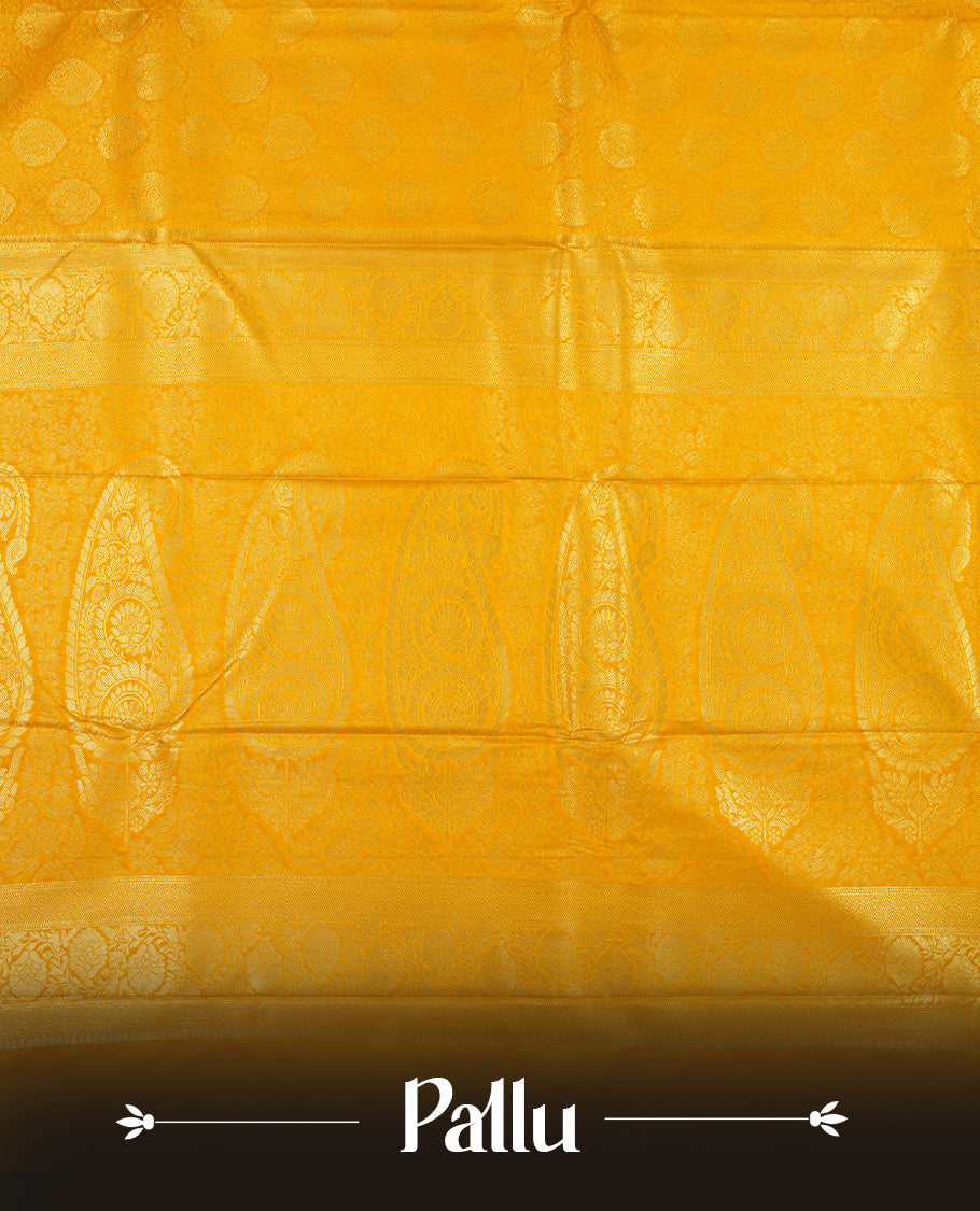 Yellow colour semi silk brocade saree featuring intricate Gold butta patterns across the body, complemented by a rich self colour woven border and pallu, paired with a matching blouse.