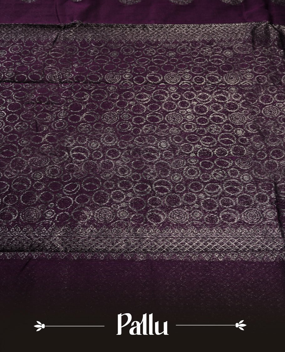 Grape colour silk cotton saree with shimmering silver zari border and intricately woven pallu, blending elegance and tradition. Paired with a matching blouse, perfect for festive celebrations and special occasions.