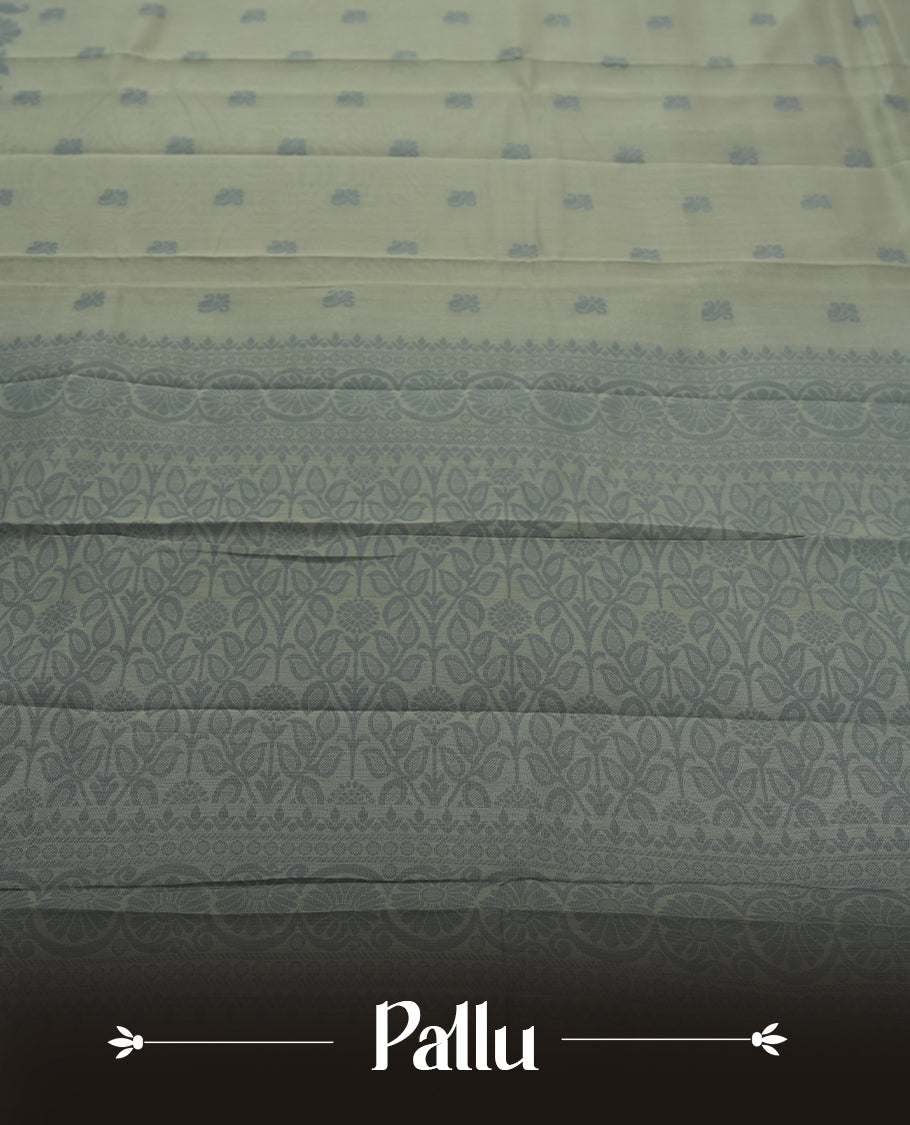 Grey colour silk cotton saree featuring elegant floral zari motifs on the body, complemented by a rich contrast border and pallu with traditional woven detailing & Comes with a matching blouse piece.
