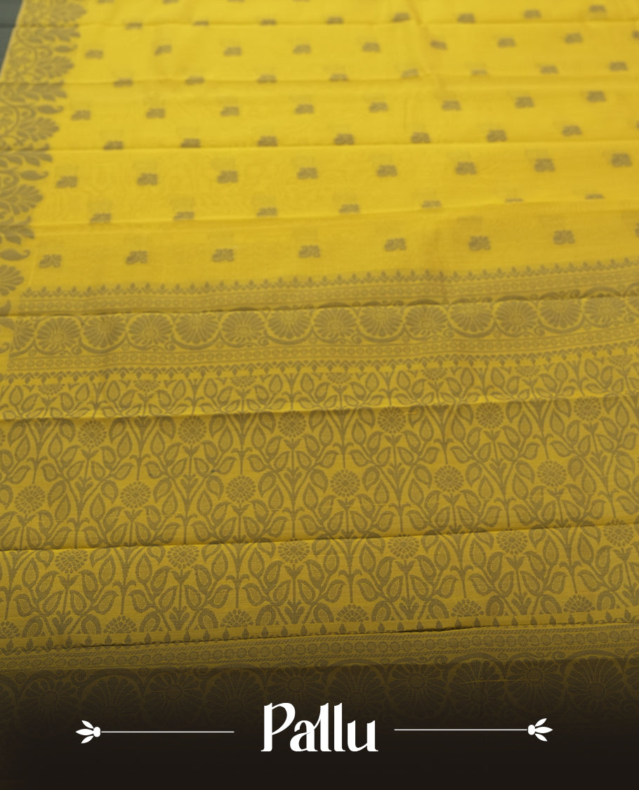 Chrome yellow colour silk cotton saree featuring elegant floral zari motifs on the body, complemented by a rich contrast dark plain grey border and pallu with traditional woven detailing & Comes with a matching blouse piece.