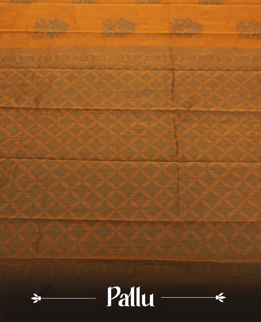 Deep mustard colour silk cotton saree featuring subtle elegant floral woven motifs on the body, complemented by a classic contrast border and pallu with intricate traditional detailing & Comes with a matching blouse piece.