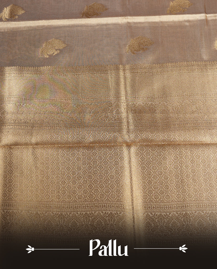 Light Gold colour tissue banaras silk saree featuring antique gold peacock zari motifs on the body with rich traditional zari border and pallu, paired with a matching blouse piece.