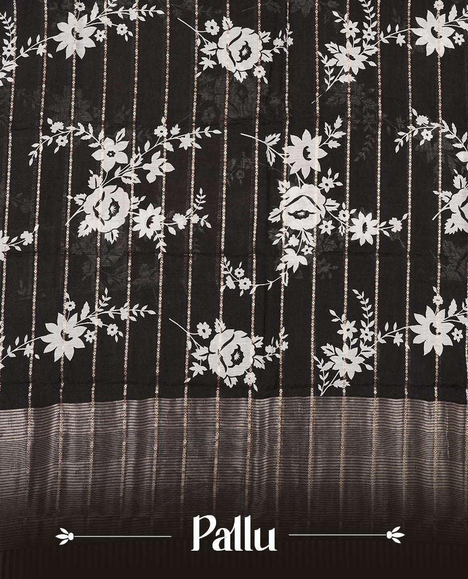Black colour chanderi silk saree with gold zari strip pattern & white Floral print pattern On body, compilmented by self colour border with antique zari pattern and a matching blouse.