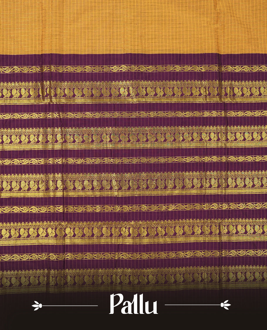 Mustard Yellow coloured mixed Kalyani cotton saree featuring golden zari checks on the body, complemented by a dark purple coloured border and pallu adorned with golden zari patterns, Paired with a matching blouse.
