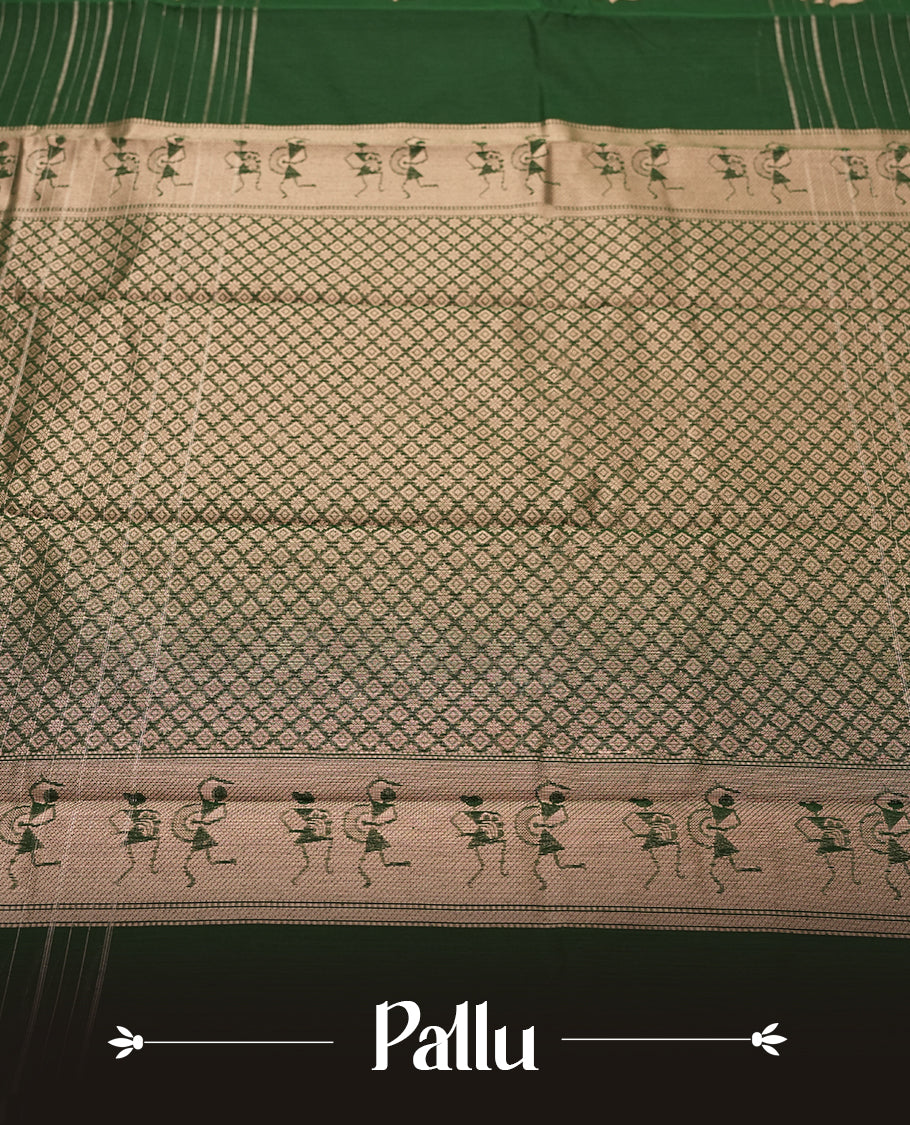 Green Colour silk cotton saree with scattered gold Warli animal motifs, gold horizontal stripes, ornate pink and gold zari border with floral patterns, gold zari pallu with diamond lattice and Warli dancer motifs, wine purple blouse.