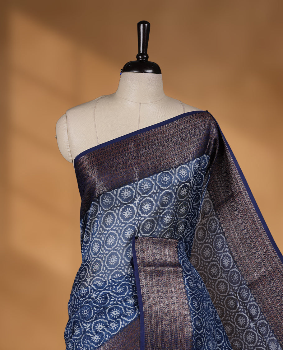 Dark blue colour chanderi silk saree with Floral block print On body, compilmented by self colour border with antique zari pattern and a matching blouse.