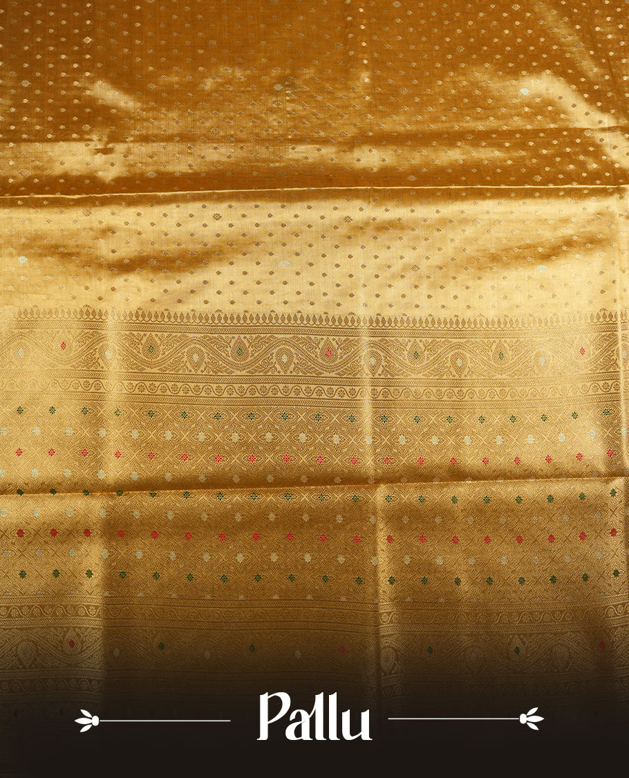 Yellow Gold colour tissue banaras silk saree featuring antique gold zari motifs on the body with rich traditional zari border and pallu, paired with a matching blouse piece.