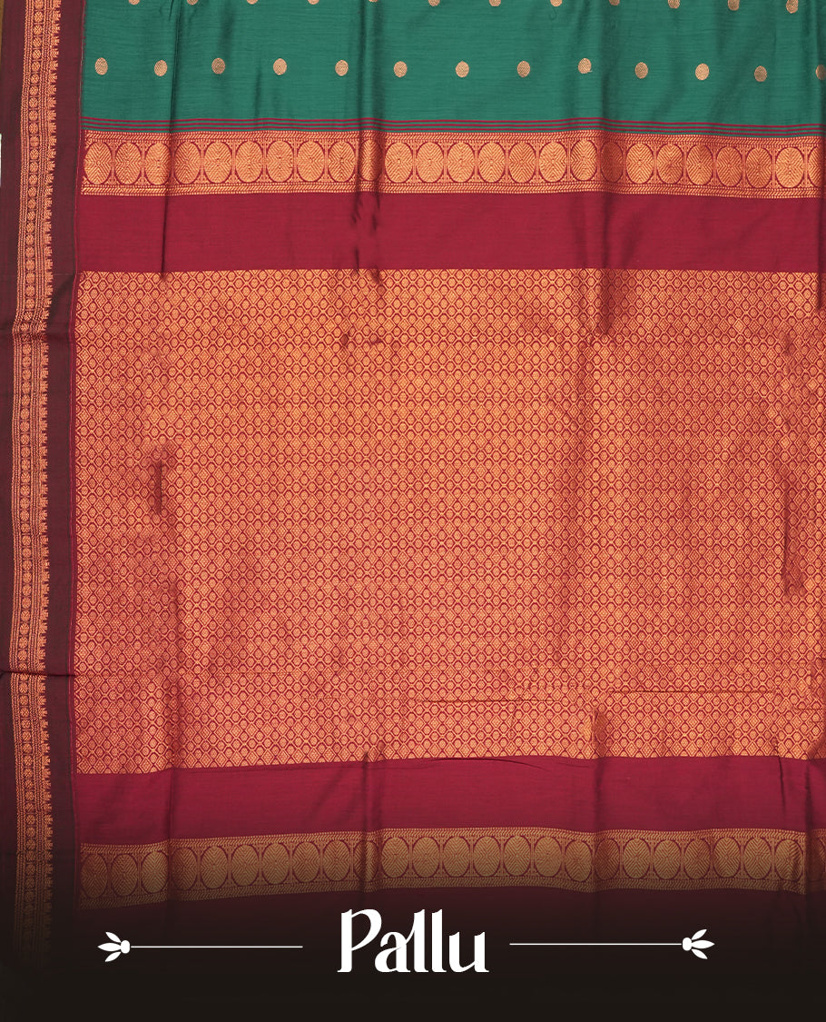 Green colour Kalyani Cotton saree with golden motifs, paired with a contrasting maroon border featuring intricate zari work & Comes with a matching blouse piece.