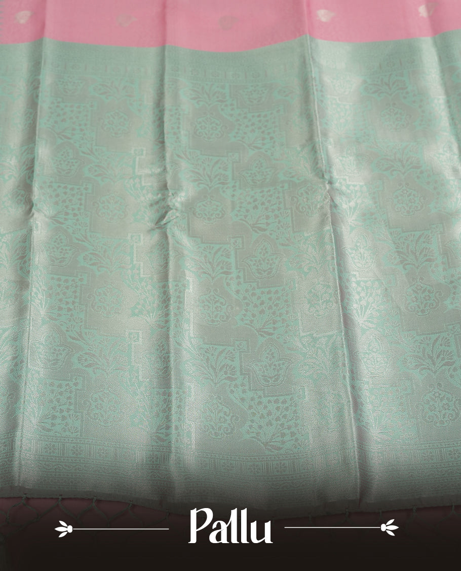 Light pink colour semi silk saree adorned with silver zari designs on the body, complemented by a contrasting light green and silver border and pallu, and paired with a matching blouse piece