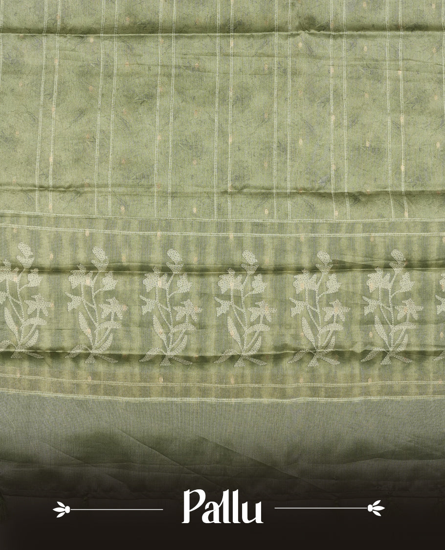 Sage green colour semi tussar saree adorned with Cream strip printed pattern across the body and Floral pattern contrast fern green colour on border, paired with a matching blouse.