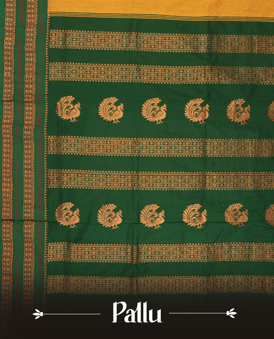 Mustard yellow Kalayani cotton saree with delicate woven motifs on the body, enhanced by a rich green zari border and pallu with traditional patterns, paired with a matching blouse piece.