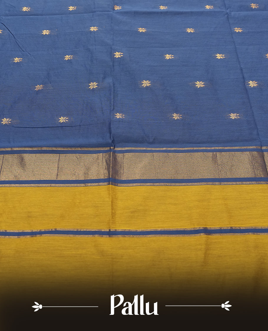 Mustard Yellow and Royal Blue Colour silk cotton saree with tiny zari star buttas, blue pallu with pinstripes and scattered buttas, slim antique-gold borders, and a plain blue blouse with matching zari edging.