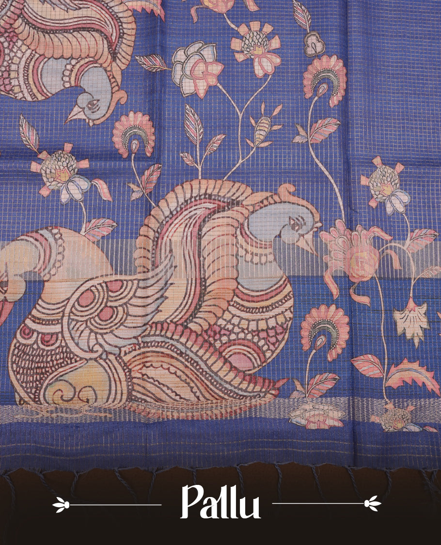 Blue colour semi-tussar silk saree featuring intricate peacock motifs on the pallu, subtle zari check pattern across the body, floral vine prints throughout, finished with tassels and paired with a matching printed blouse piece.