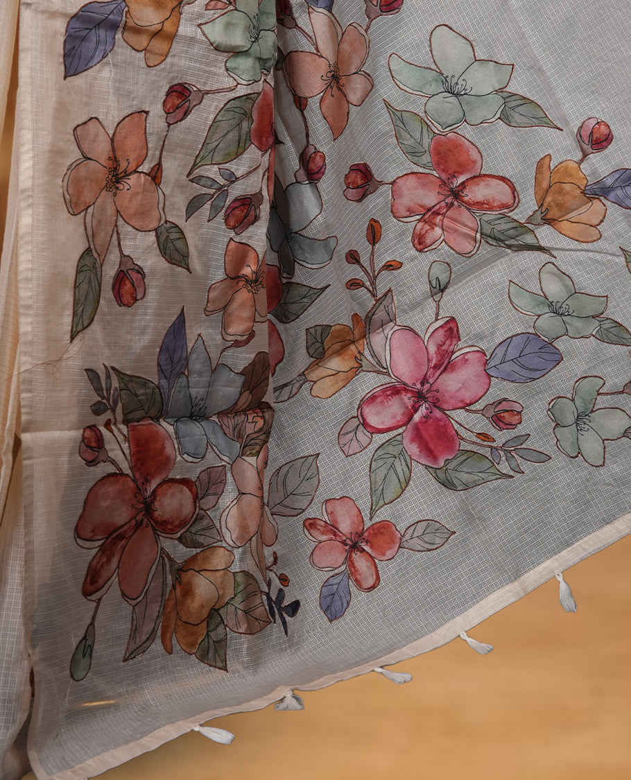 Ivory off white semi tusser silk saree featuring delicate multicolour floral prints across the pallu and lower body finished with a subtle self border and paired with a matching floral printed blouse.