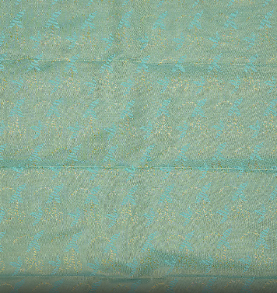 Sandalwood colour Semi silk saree featuirng Cream colour patterns on body, complemented by contrast Green colour with gold zari border, paired with matching blouse piece.