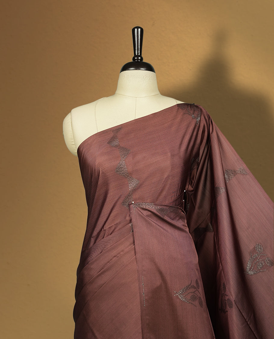 Brown colour semi soft silk saree with delicate woven motifs on the body, complemented by a beautifully designed pallu with tassels & Paired with a matching blouse piece, this drape exudes timeless elegance.