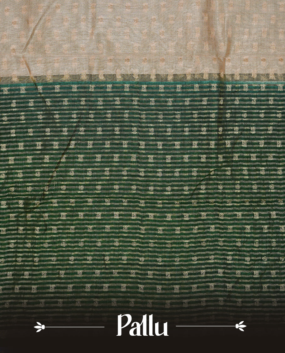 Cream colour Semi Tussar silk saree featuring an Gold zari motifs on body, accentuated by a contrast Dark green border adorned with intricate gold zari work, paired with a matching blouse piece.