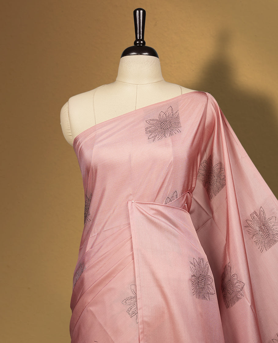 Soft peach colour semi soft silk saree, adorned with subtle woven floral motifs on the body & The design is elevated with an elegant zari border and pallu with tassels, paired with a matching blouse.
