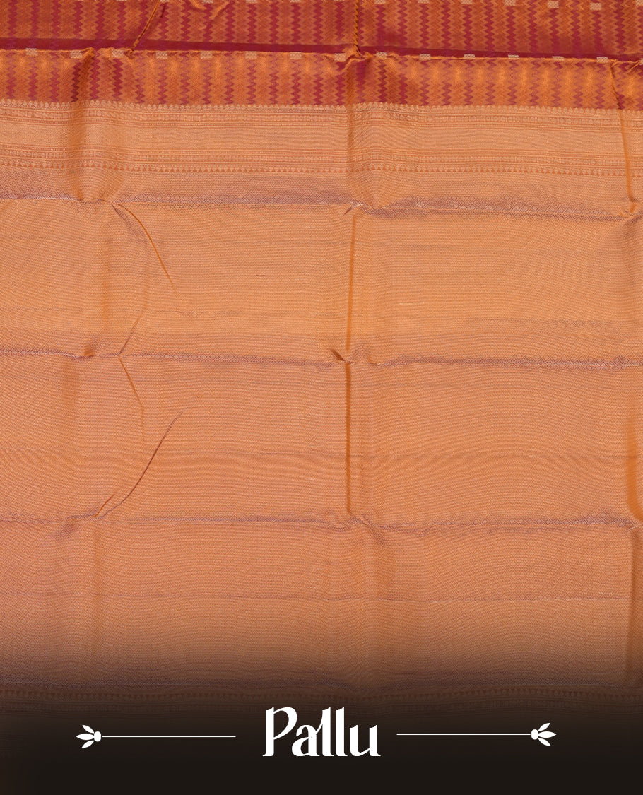 Burnt orange colour Vasundhara silk saree adorned with all-over purple zigzag motifs on the body, complemented by a self colour with gold line pattern border and paired with a matching blouse piece.