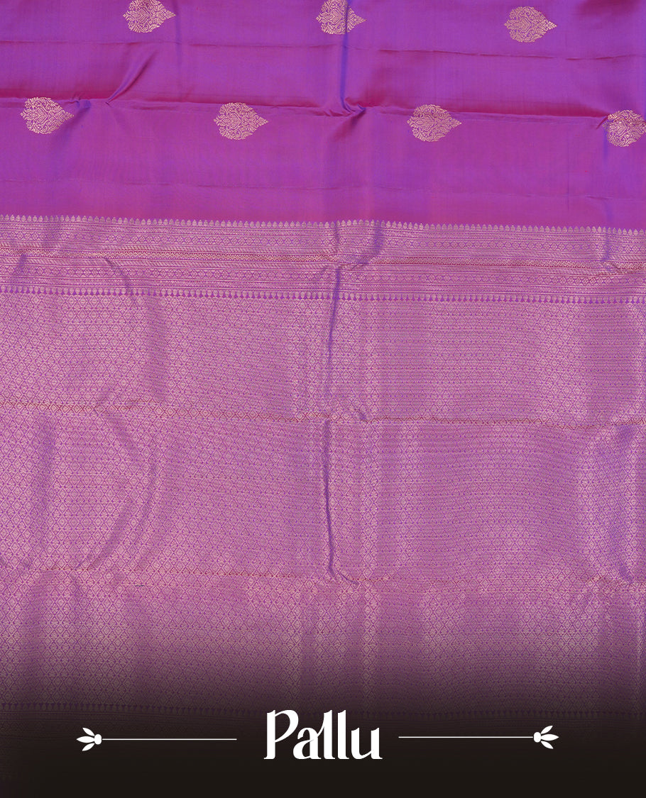 Indigo colour Vasundhara silk saree adorned with all-over gold motifs on the body, complemented by a self colour with gold tarditional border and paired with a matching blouse piece.