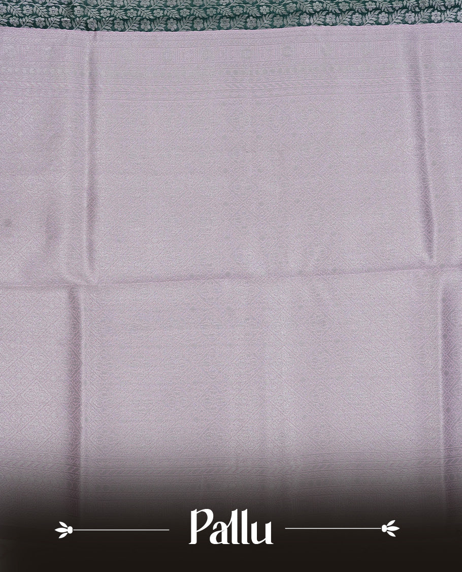 Green colour semi silk saree featuring Silver zari Floral pattern on body, complemented by contrast Pink colour with silver zari border, comes with matching blouse piece.