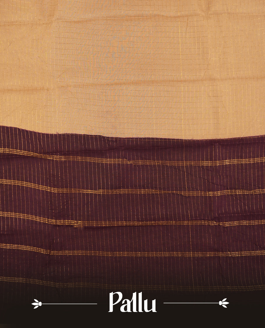 Beige colour Chettinad cotton saree adorned with subtle checked patterns on the body, complemented by an exquisite dark maroon border featuring golden peacock motifs & Paired with a matching blouse piece.