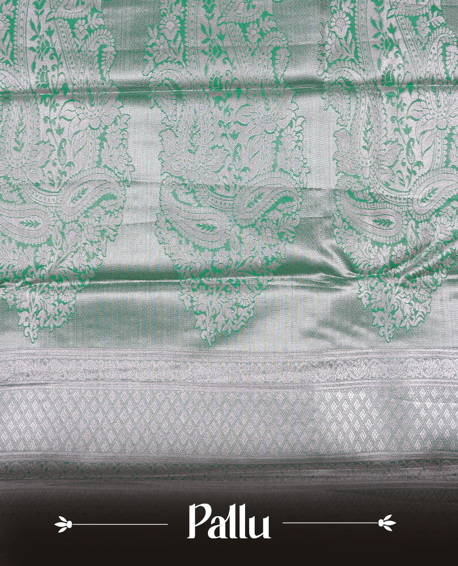 Light green colour tissue saree featuring rose gold zari floral kodi pattern on the body, highlighted by a self colour border with rose gold traditional zari, paired with a matching blouse piece.