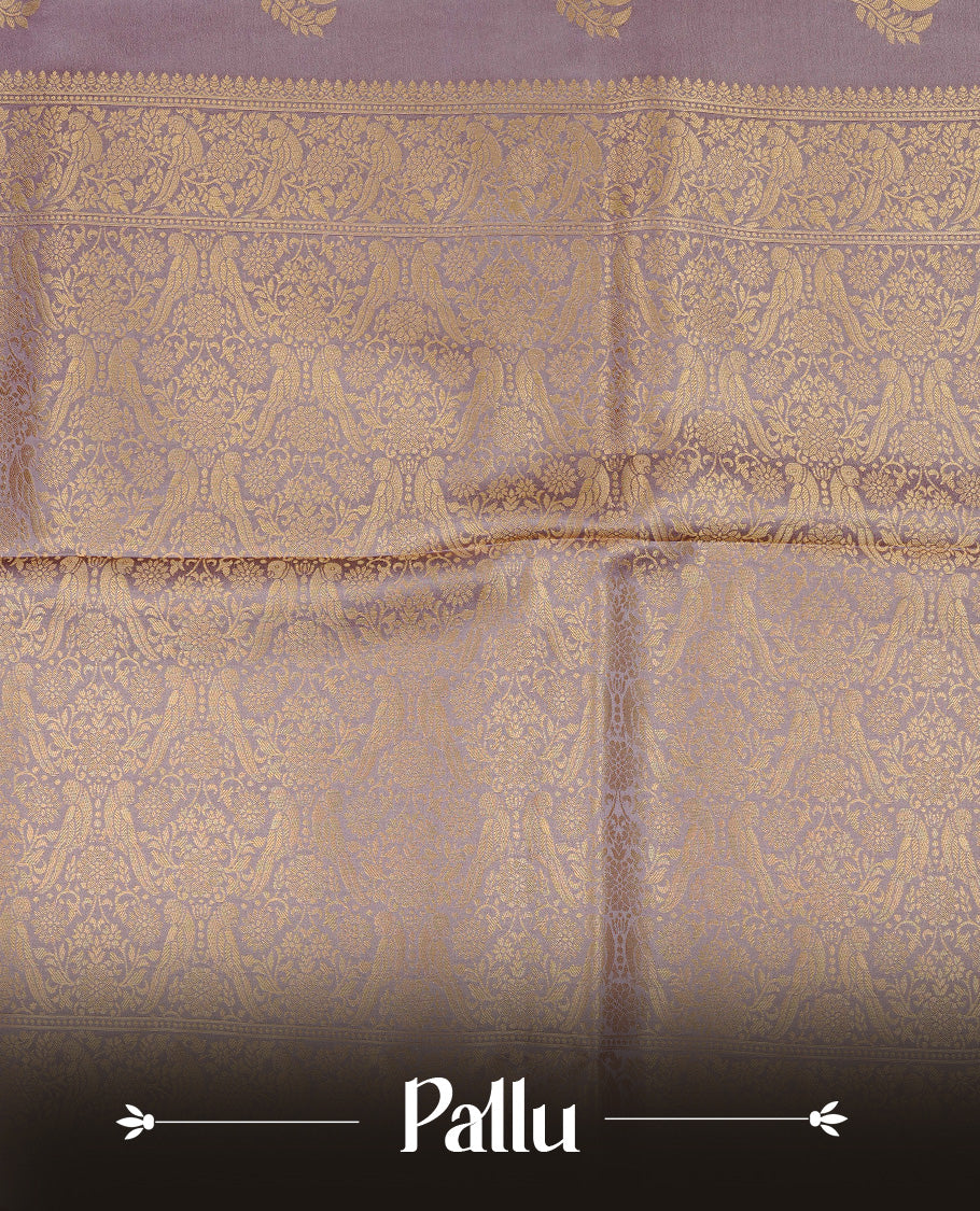 Pastel Lavender colour Mulberry silk saree featuring Gold zari bird motifs on body, complemented by self colour with gold zari border, comes with matching blouse piece.
