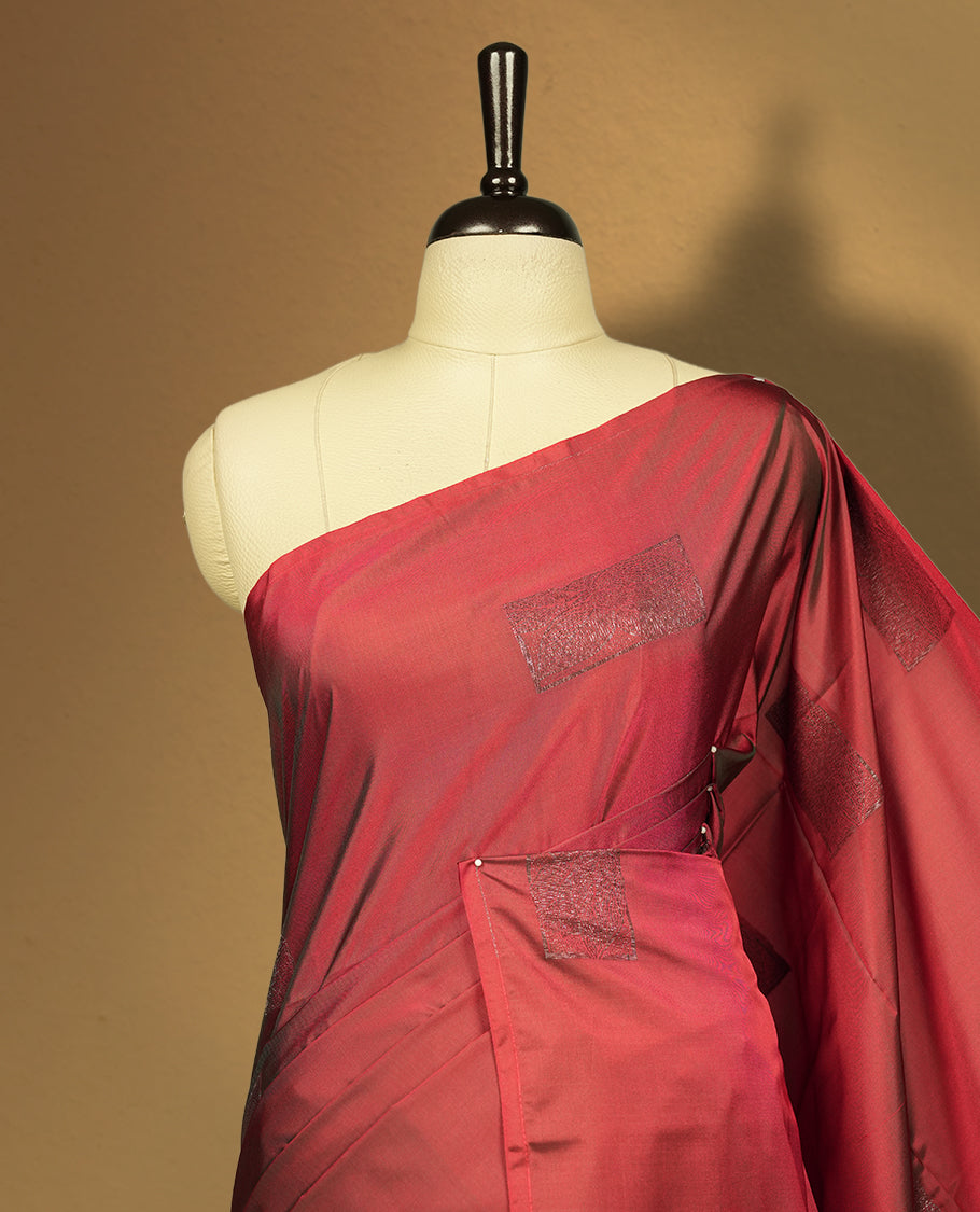 Dual tone medium copper & green semi soft silk saree adorned with woven square motifs on the body, complemented by a rich contrast woven pallu with tassel detailing & Comes with a matching blouse piece.