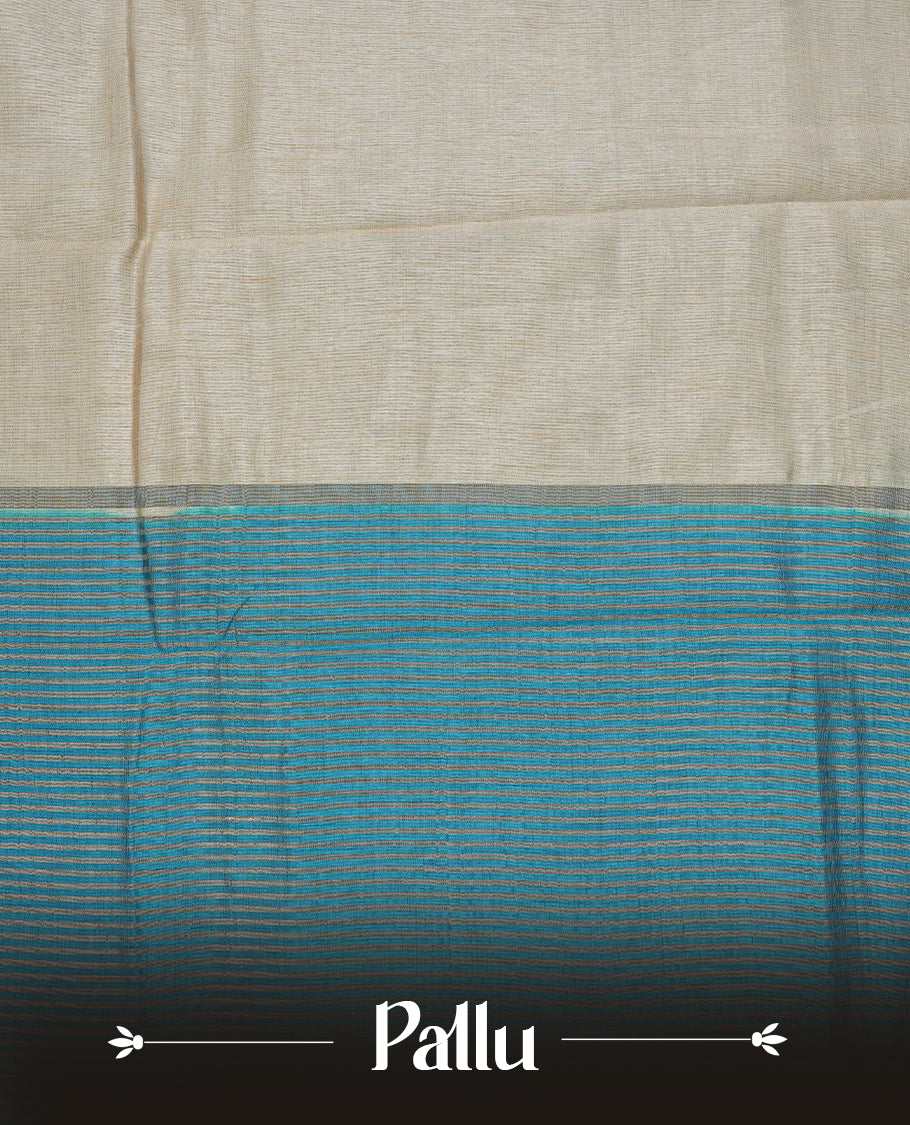 Cream colour Semi Tussar silk saree featuring an elegant plain body, accentuated by a contrast Blue border adorned with intricate gold floral kodi zari work, paired with a matching blouse piece.