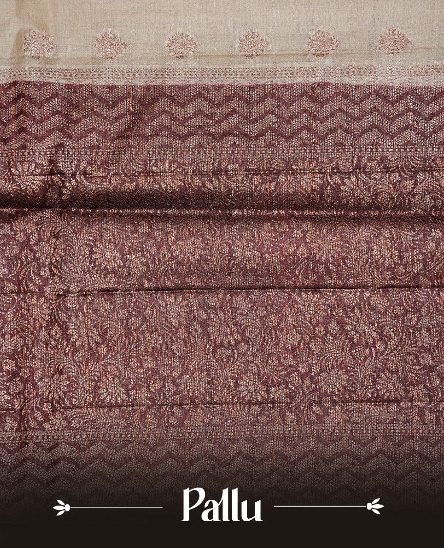 Cream Colour Tussar silk saree featuring Antique Zari motifs on body, Finished with contrast Chocolate colour Zigzag zari pattern border, paired with matching blouse piece.
