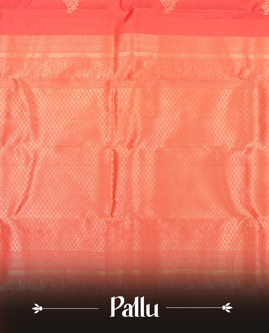 Reddish peach colour Vasundhara silk saree featuring Gold zari motifs across the body, finished with a self‑coloured traditional border and a coordinating blouse.