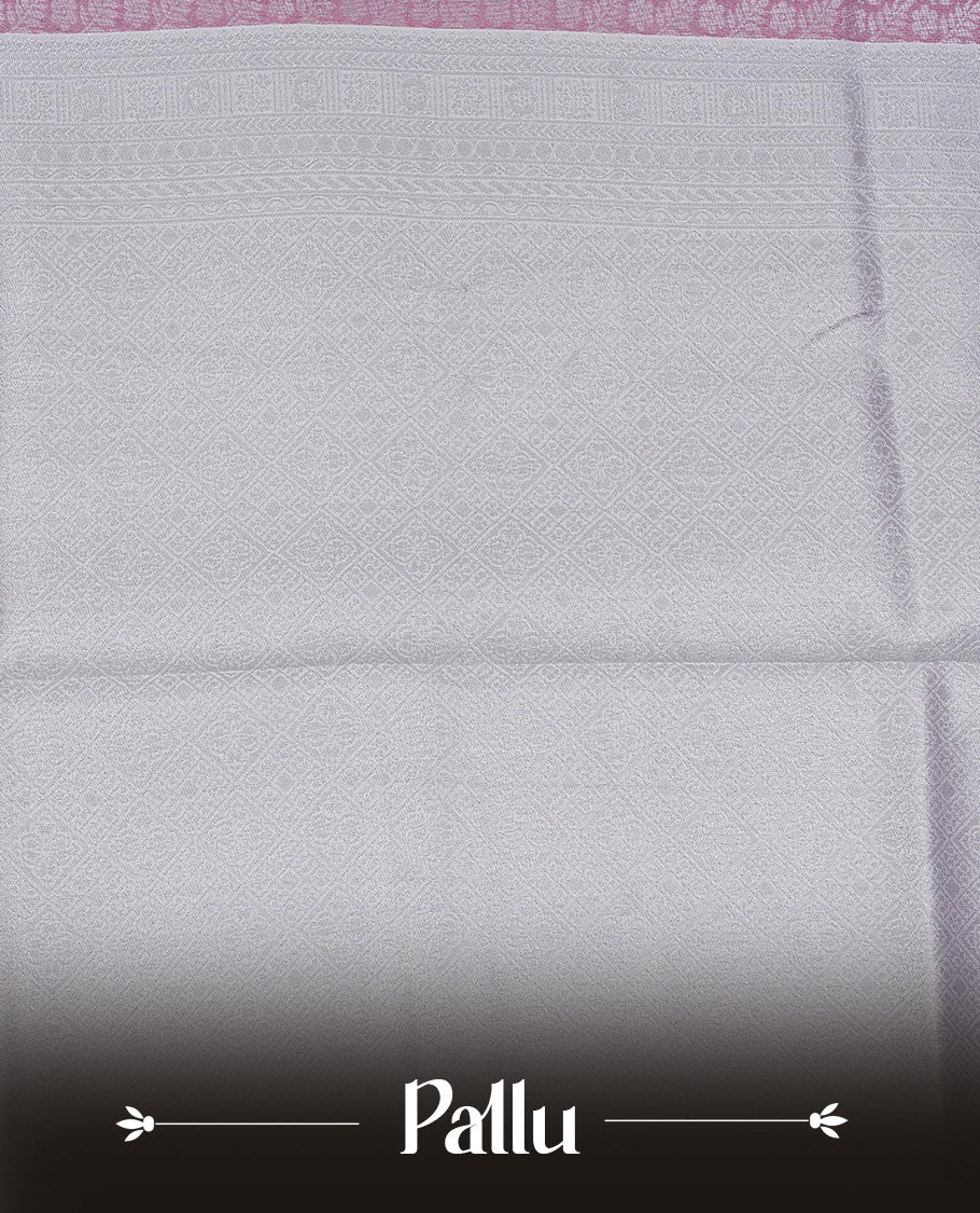 Pink colour semi silk saree featuring Silver zari Floral pattern on body, complemented by contrast Lavender colour with silver zari border, comes with matching blouse piece.