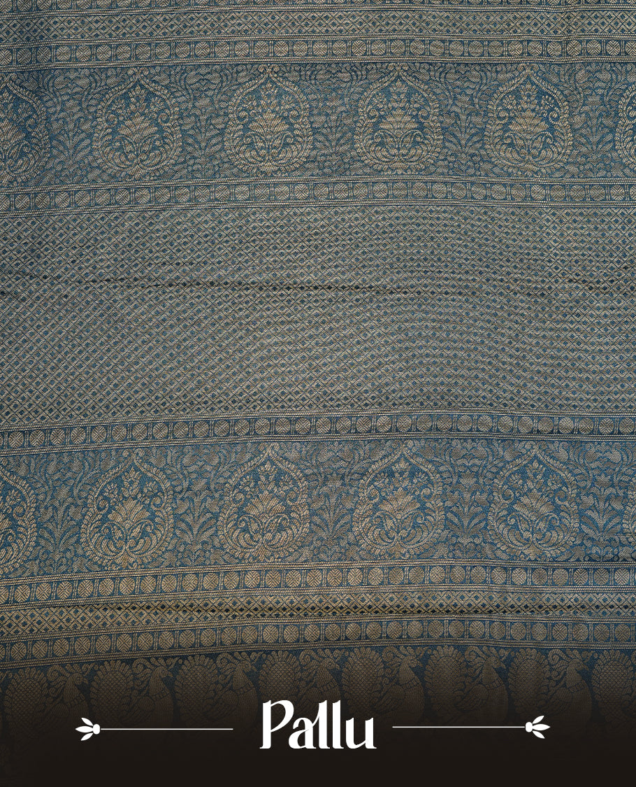Navy blue colour soft silk saree featuring gold zari pattern on body, complemented by self colour with traditional border, paired with matching blouse piece.