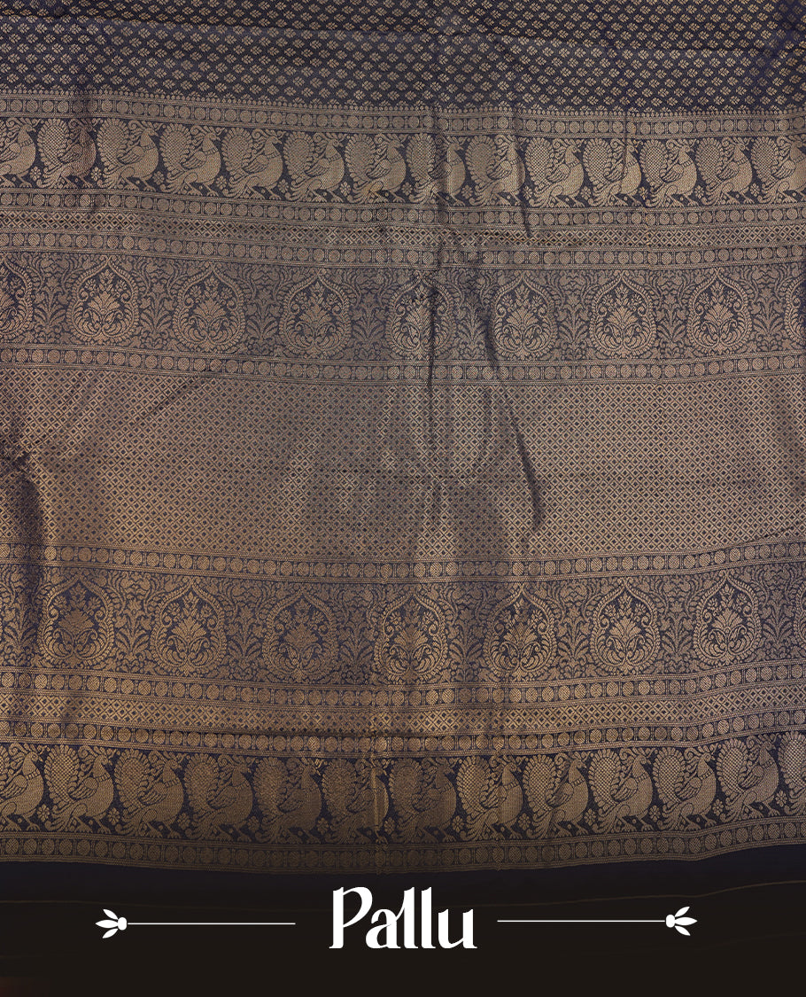 Navy blue colour semi soft silk saree featuring gold zari motifs on across body, self colour border with traditional gold zari pattern, pallu and paired with matching blouse.