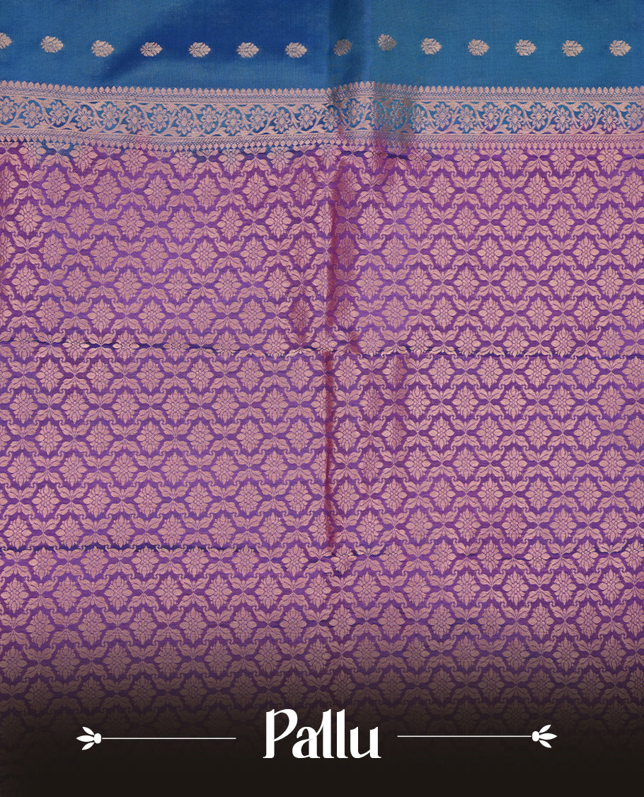 Peacock colour Soft silk saree featuring gold zari floral motifs on the body, complemented by a contrast Indigo traditional zari floral kodi border and pallu, paired with a matching blouse piece.