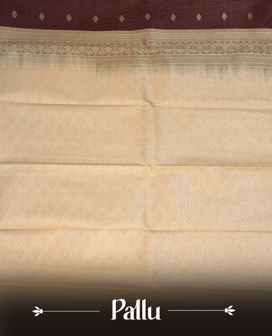 Chocolate brown coloured soft silk saree featuring gold zari stripes and motifs across the body, enhanced with a contrast Cream border and pallu, paired with a matching contrast blouse piece.