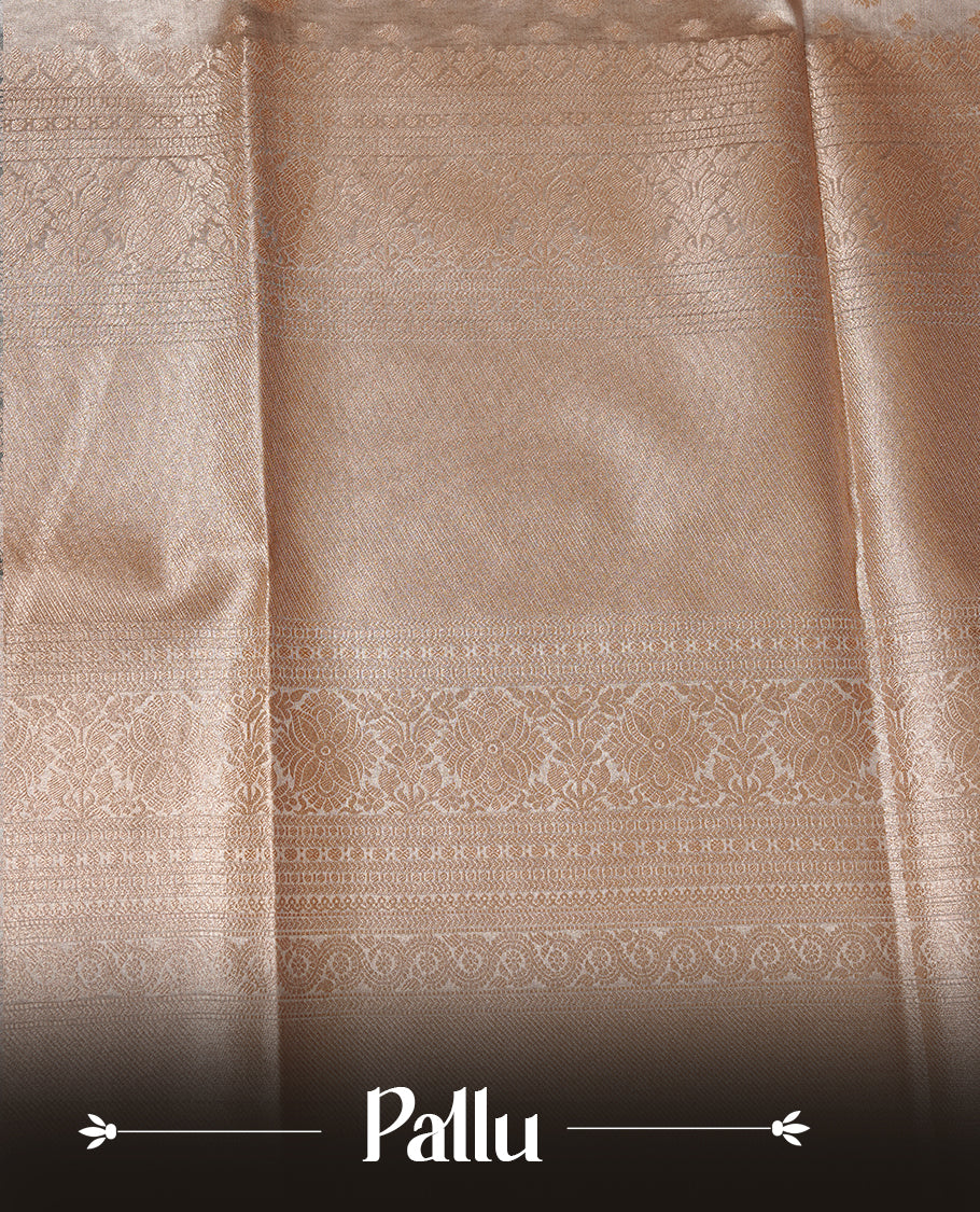 Pastel grey colour semi tissue silk saree featuring floral zari motifs on body, complemented by gold zari traditional border, paired with matching blouse piece.