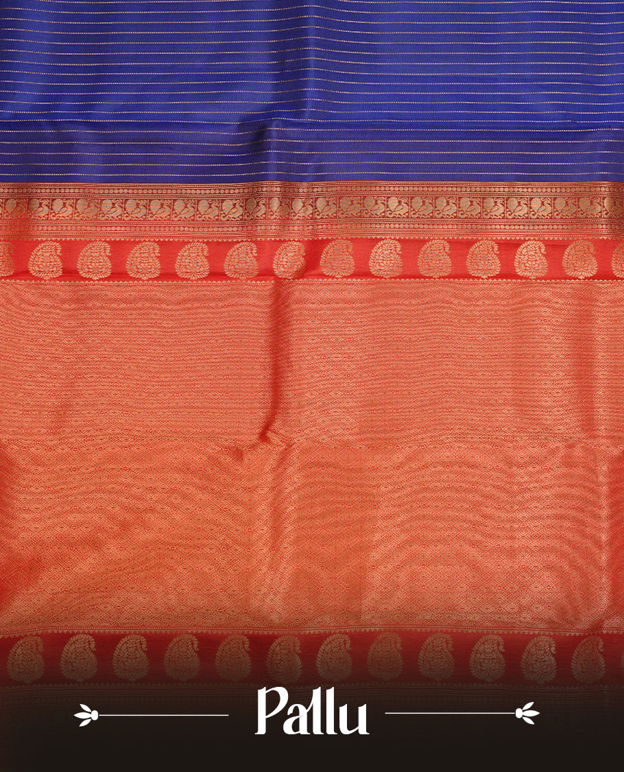 Navy blue colour traditional kancheepuram silk saree featuring gold zari strpies on body, complemented by contrast red colour with gold zari traditional border, paired with matching blouse piece.