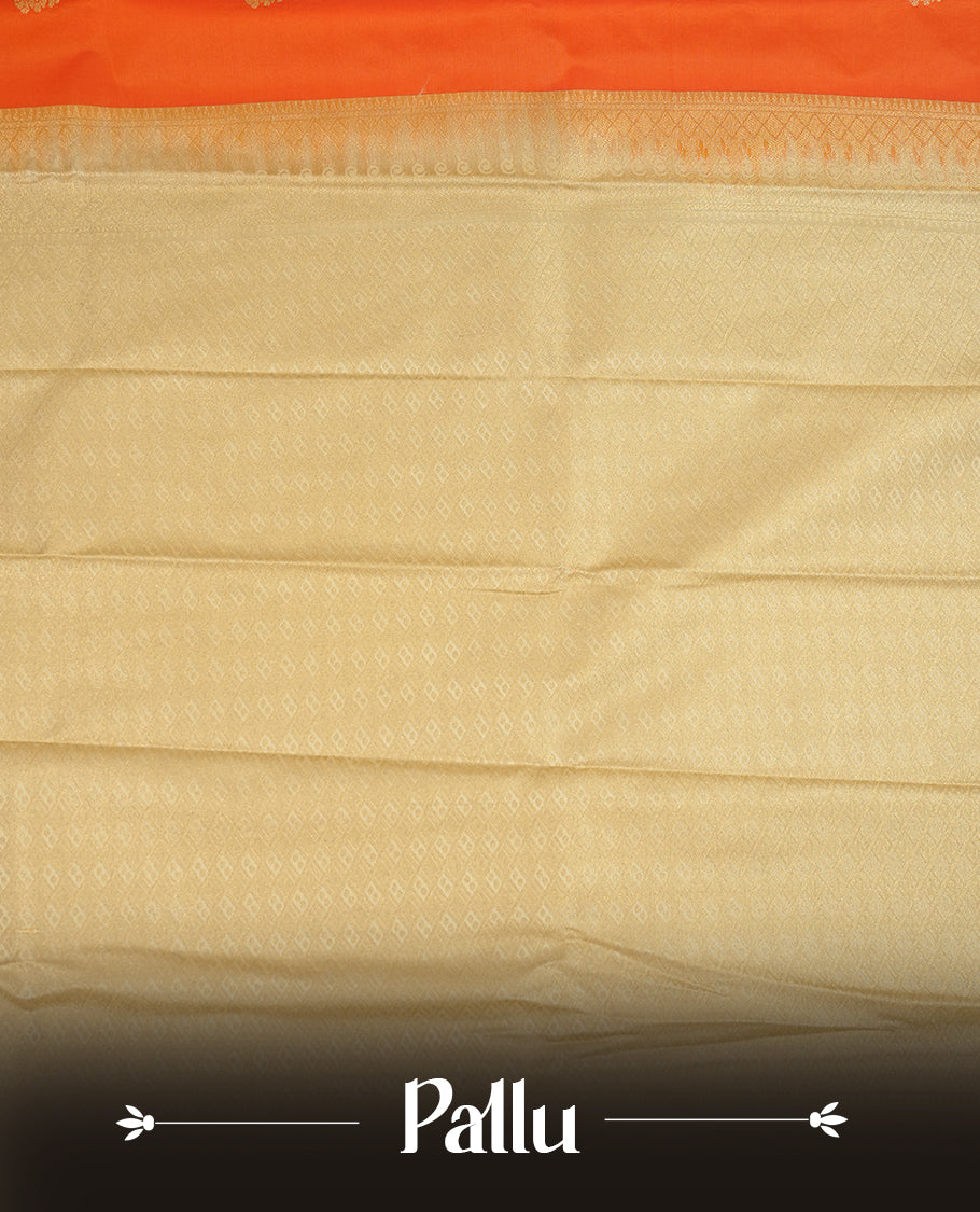 Orange coloured soft silk saree featuring gold zari motifs across the body, enhanced with a contrast Cream border and pallu, paired with a matching contrast blouse piece.