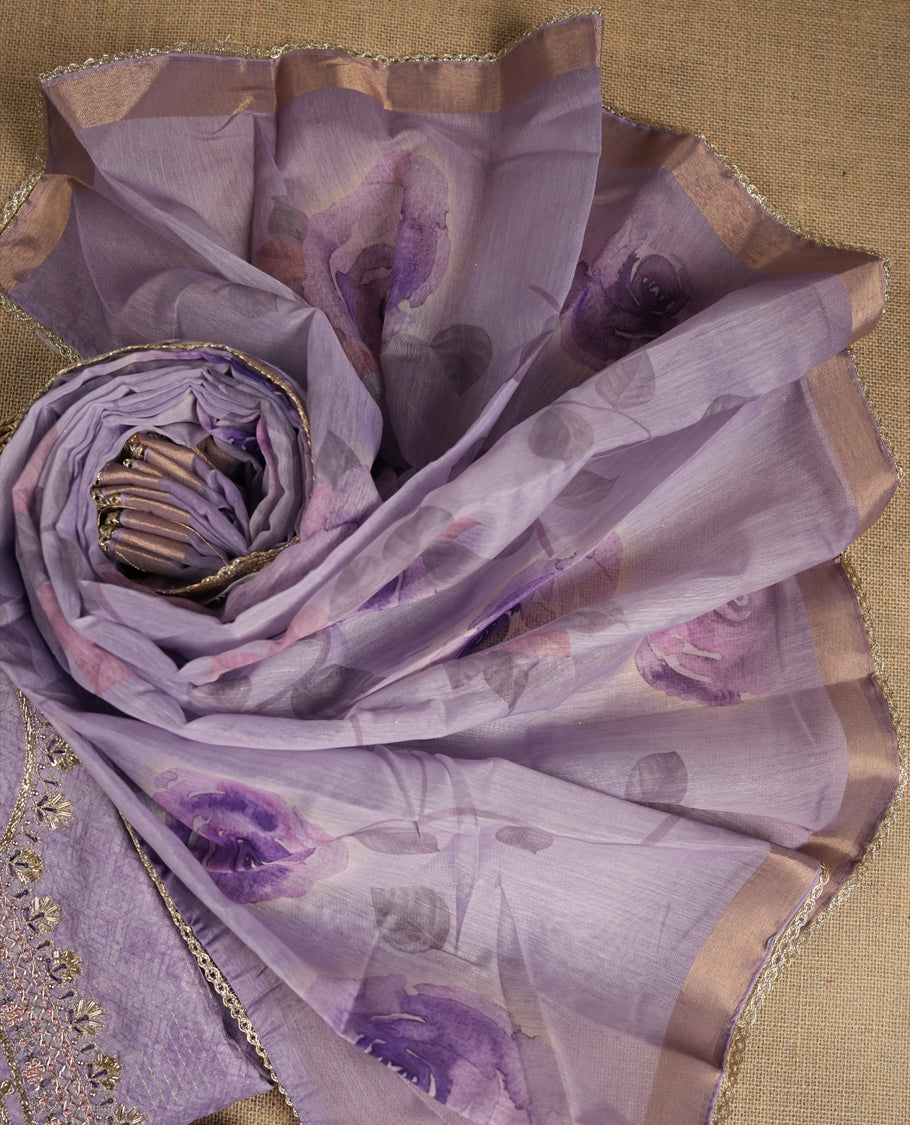 Lavender colour suit material adorned with pearls and cut beads embroidery work on the neckline, exuding a graceful charm & Paired with a floral printed dupatta and a matching plain bottom.
