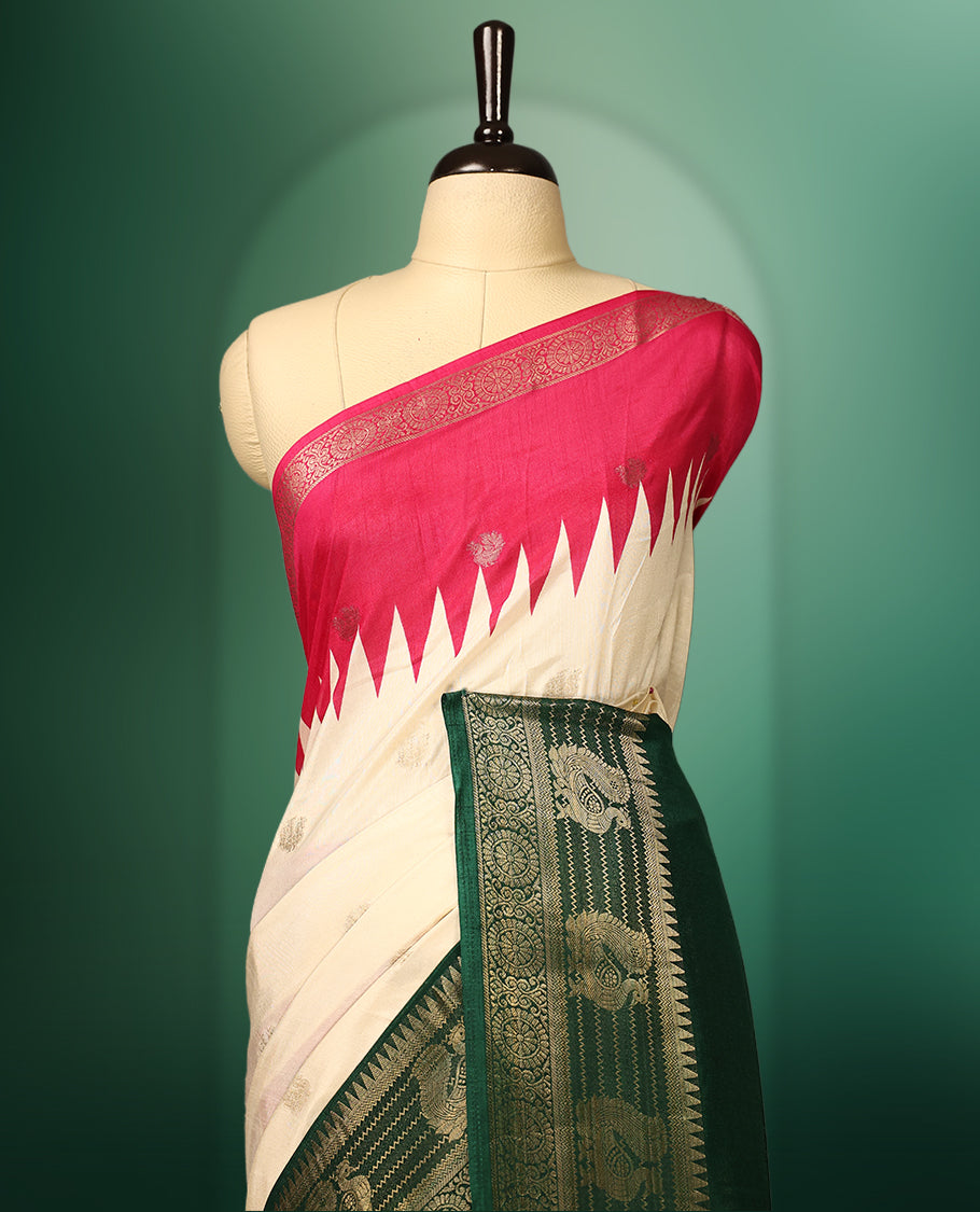 Off white colour saree with delicate golden motifs, highlighted by a striking pink upper border, rich green zari woven border, and a contrasting red and green pallu with intricate floral and geometric designs, paired with a matching blouse